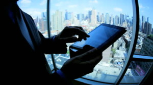 stock-footage-close-up-silhouette-caucasian-male-hands-using-touch-screen-technology-in-office-overlooking